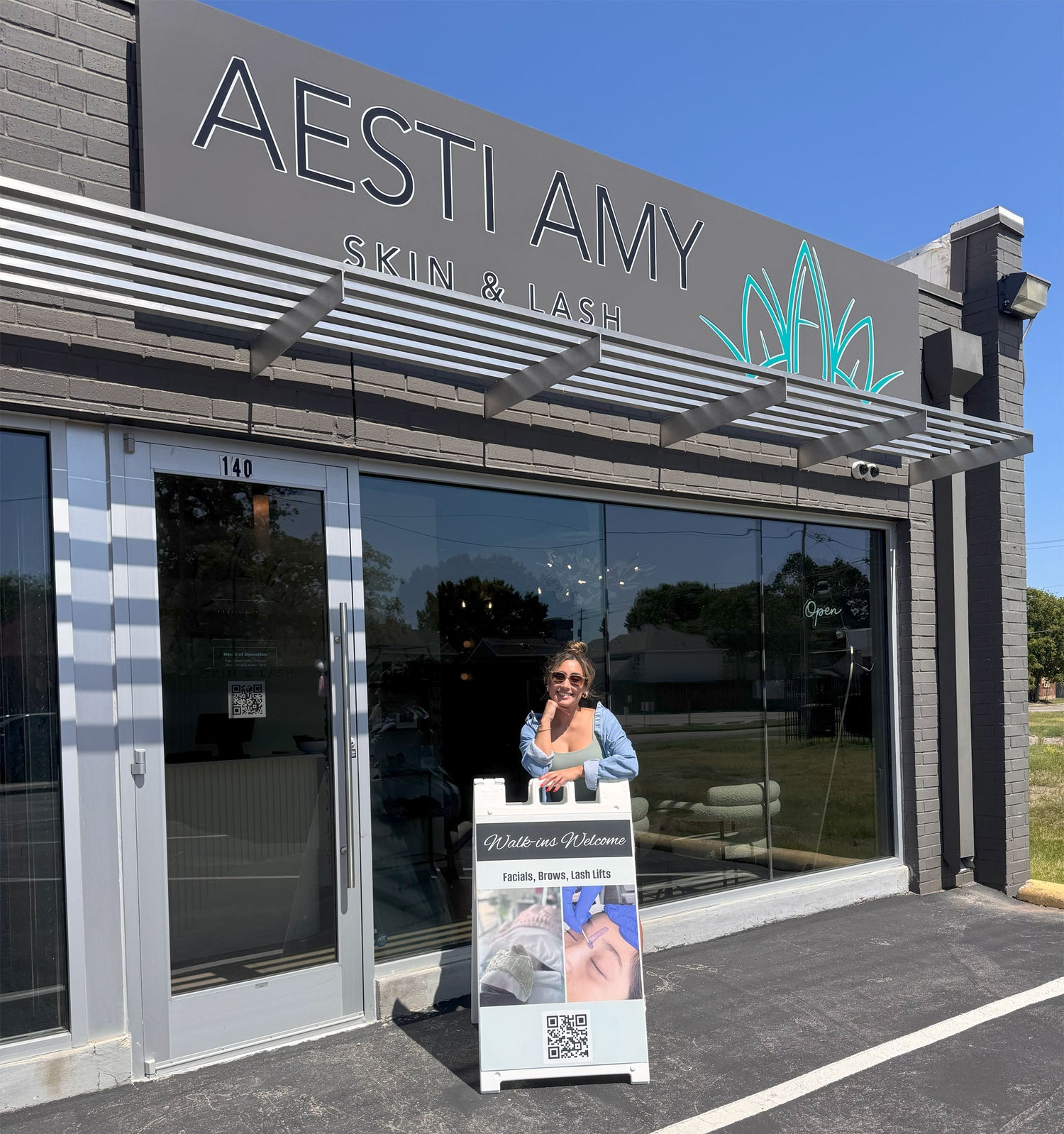 Aesti Amy standing in front of her store, Aesti Amy Skin & Lash Studio.